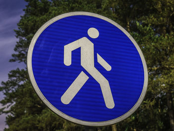 Close-up of road sign against tree