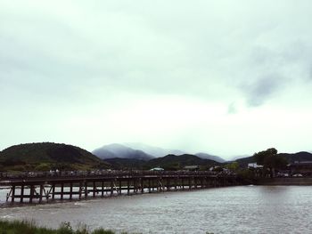 Scenic view of river against cloudy sky