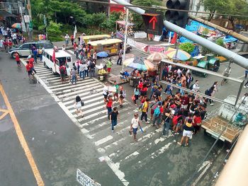 High angle view of people standing on road in city