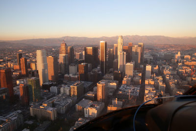 Cityscape against clear sky seen through helicopter