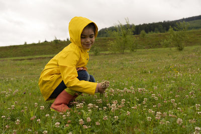 Side view of boy standing on field