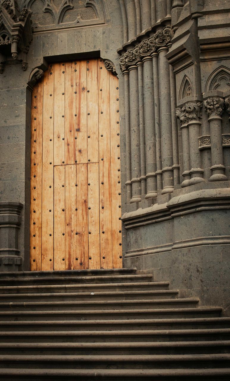 architecture, built structure, wood, building, building exterior, no people, history, the past, staircase, entrance, pattern, day, wall, religion, door, closed, place of worship, travel destinations, ancient history, old, facade, low angle view, outdoors, stairs, belief, column, iron