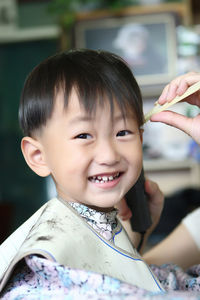 Portrait of smiling boy at barber shop