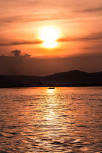 Scenic view of sea against romantic sky at sunset