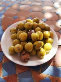 High angle view of grapes in container on table