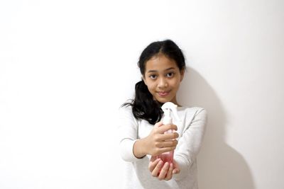 Portrait of a smiling young woman over white background