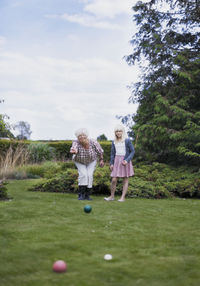 Grandmother and granddaughter playing petanque