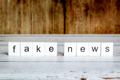 Close-up of text with blocks on table