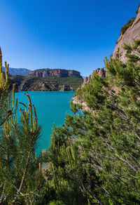 Scenic view of bay against clear blue sky