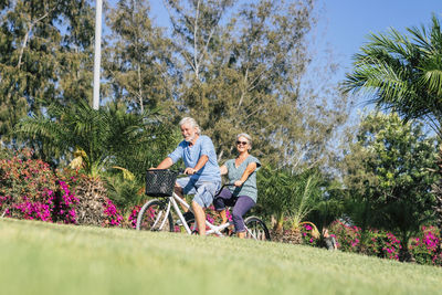 People riding bicycle against plants