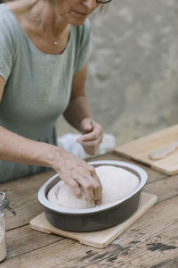 Midsection of man preparing food on table