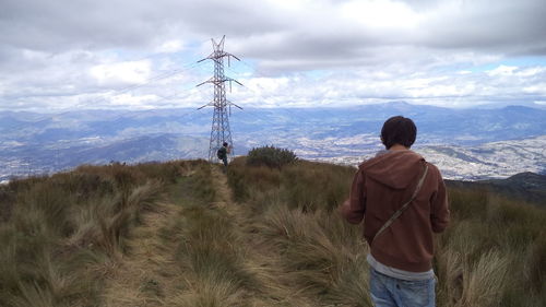 Scenic view of mountains against cloudy sky