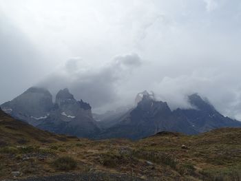 Scenic view of mountains against cloudy sky