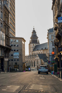 City street amidst buildings against clear sky