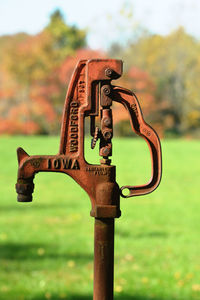 Close-up of rusty metal on field at park