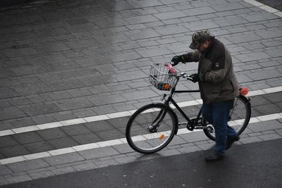 Man riding bicycle on street in city