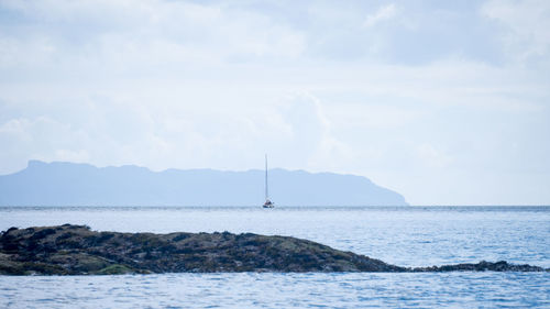 Sailboat in sea against sky