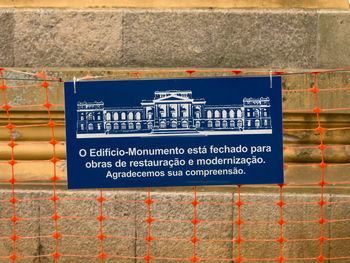 Close-up of information sign on wall