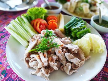 High angle view of chopped vegetables in plate on table