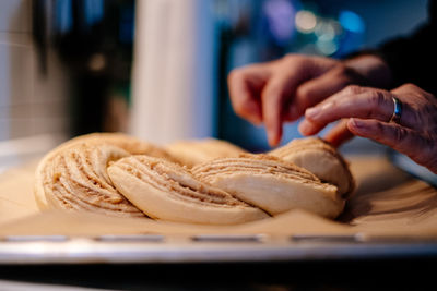 Close up of human hand preparing easter cake dough