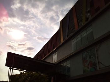 Low angle view of modern building against sky during sunset