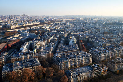 Aerial view of cityscape on sunny day against sky