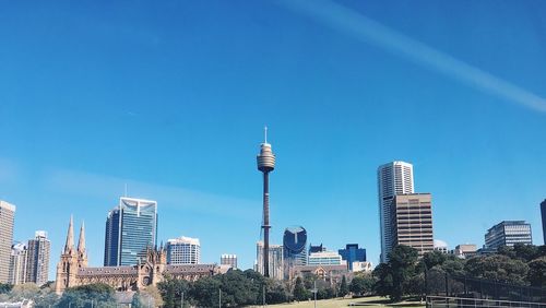 Skyscrapers in city against blue sky