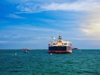 Ship sailing on sea against sky