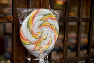 Close-up of lollipop against window