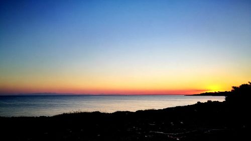 Scenic view of calm sea at sunset