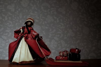 Woman with red umbrella on table