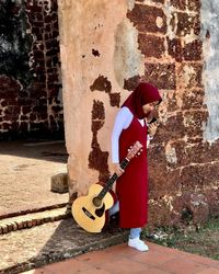 Rear view of man playing guitar