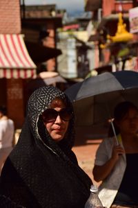 Portrait of friends at market in city