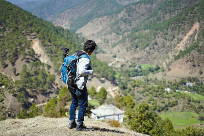 Rear view of man walking on mountain