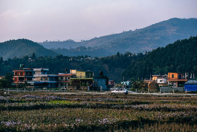 Houses on field against sky