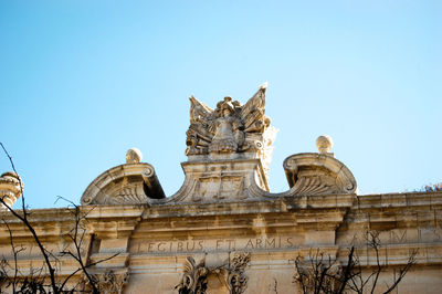 Low angle view of statue against blue sky