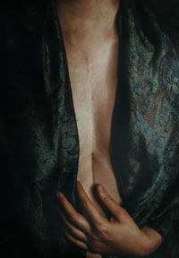 Midsection of shirtless woman