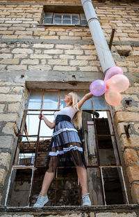 Rear view of woman sitting on steps