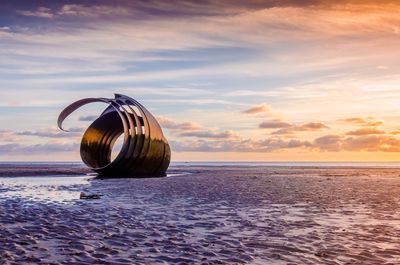View of sea against cloudy sky during sunset