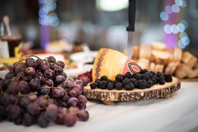Close-up of fruits and cheese on plate on table