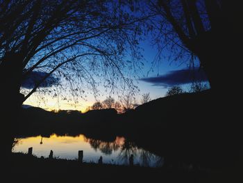 Scenic view of silhouette trees against sky at sunset