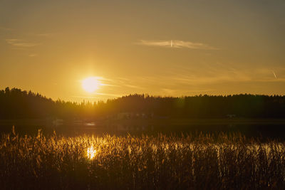 Scenic view of lake against sky during sunset