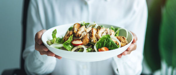 Midsection of woman holding food