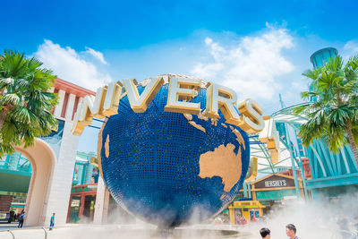 Low angle view of amusement park against sky