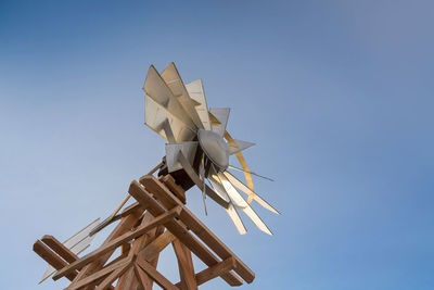 Low angle view of modern windmill against clear blue sky