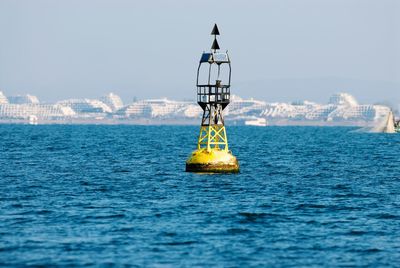 Buoy in sea against clear sky