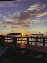Silhouette pier on sea against sky during sunset