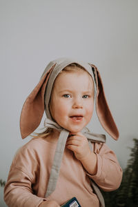 Toddler baby girl in funny hat with ears having fun