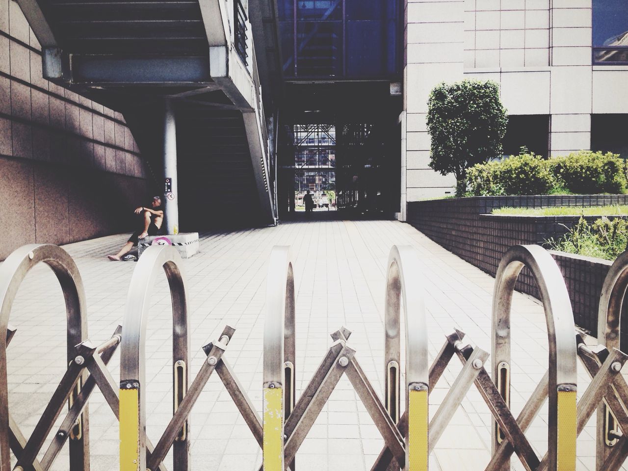 architecture, built structure, building exterior, railing, building, bicycle, metal, day, city, residential structure, window, outdoors, no people, sunlight, wall - building feature, residential building, steps, transportation, shadow, balcony