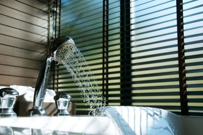 Window blinds and bathtub in restroom